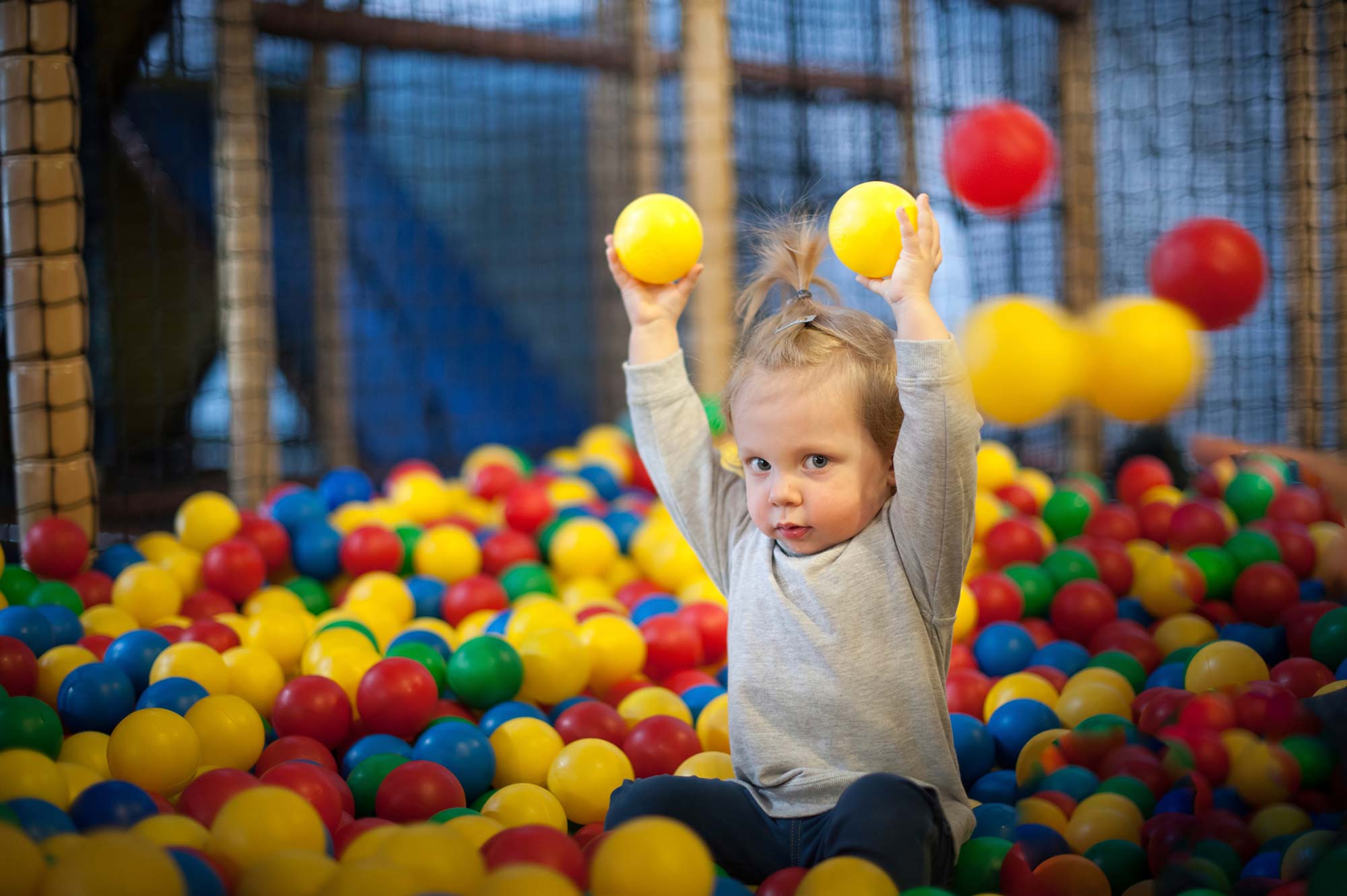 A young girl in a ball pool